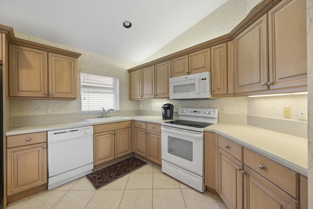 kitchen with sink, white appliances, light tile patterned flooring, and lofted ceiling