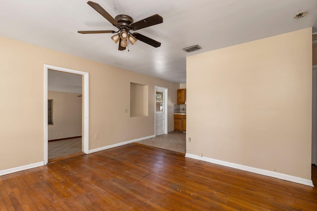 spare room featuring ceiling fan and wood-type flooring