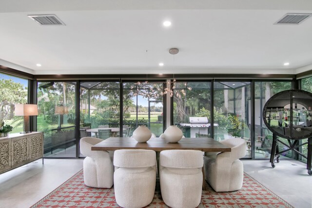 sunroom featuring an inviting chandelier and plenty of natural light