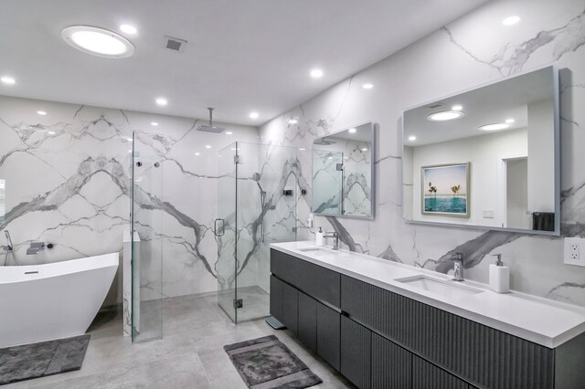 bathroom with tile walls, vanity, and shower with separate bathtub