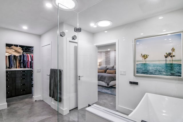 bathroom featuring concrete floors and a tub to relax in