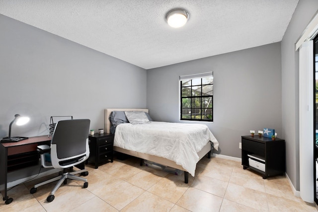 5280 SE Dell St, Stuart, FL 34997 - bedroom with a textured ceiling, light tile patterned flooring, and baseboards