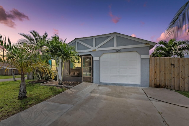 5280 SE Dell St, Stuart, FL 34997 - view of front of home with stucco siding, concrete driveway, and a garage