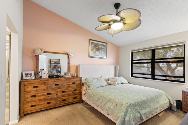 carpeted bedroom with ceiling fan, vaulted ceiling, and a textured ceiling