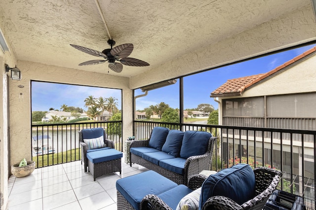 sunroom featuring ceiling fan