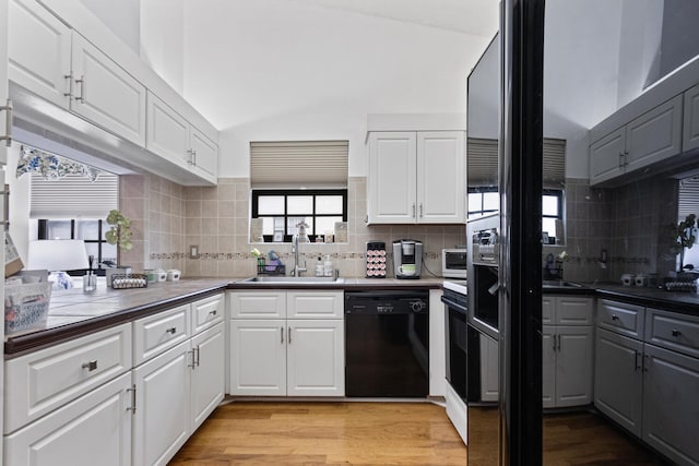 kitchen with dishwasher, sink, and white cabinets