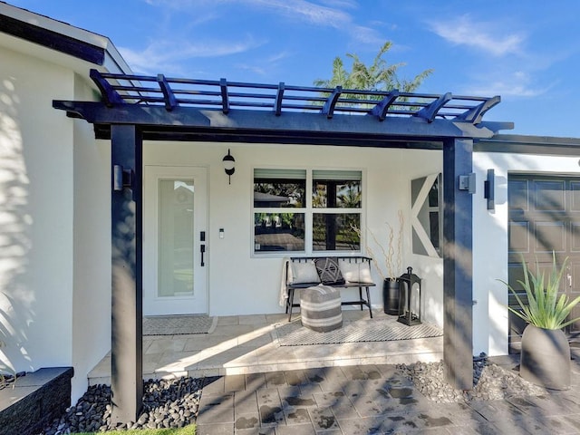 property entrance featuring a pergola