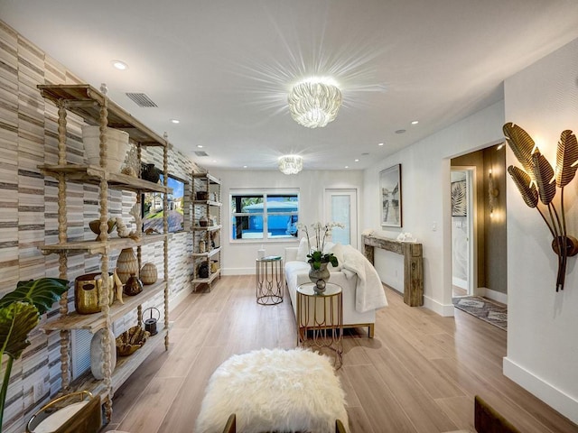 living room with a chandelier and light hardwood / wood-style flooring