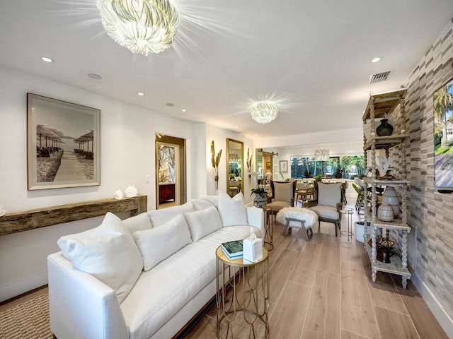 living room featuring an inviting chandelier and light hardwood / wood-style floors