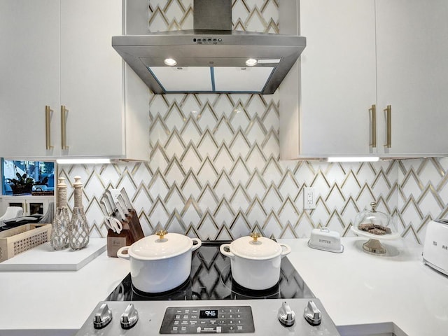 kitchen with white cabinets and wall chimney range hood