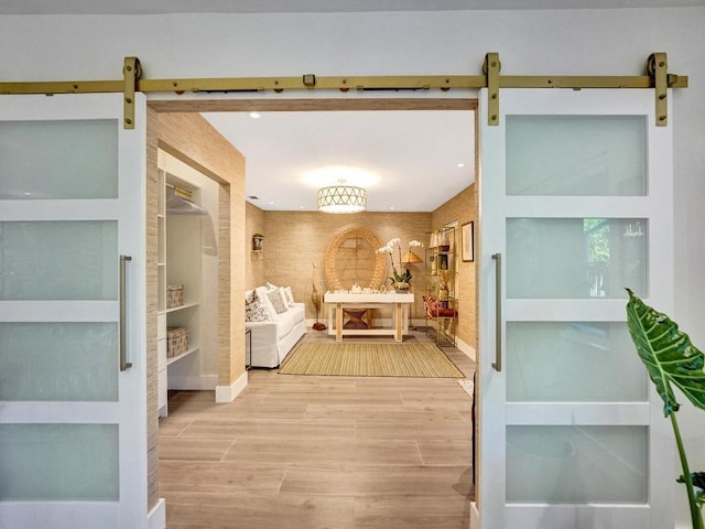 interior space with built in shelves and a barn door