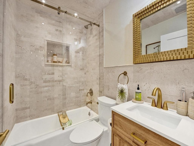 full bathroom with toilet, backsplash, tile walls, vanity, and shower / bath combination with glass door