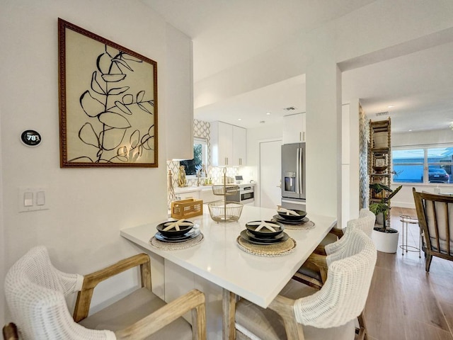 dining space featuring hardwood / wood-style floors