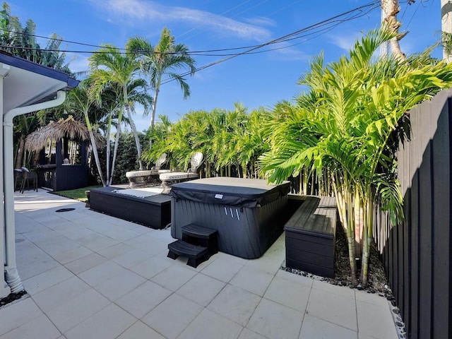 view of patio / terrace with a hot tub