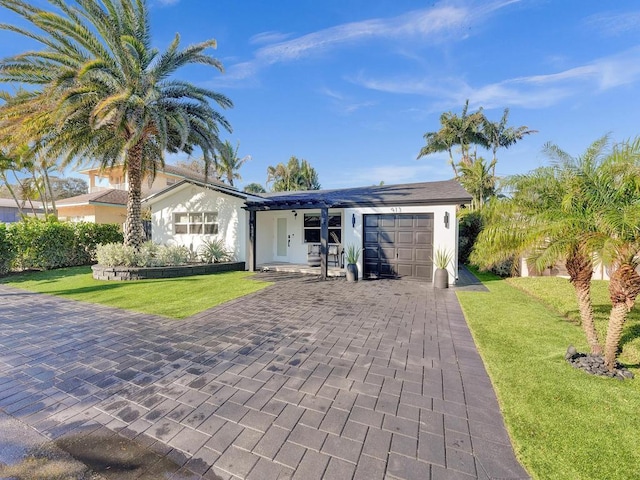 ranch-style house with a front yard and a garage