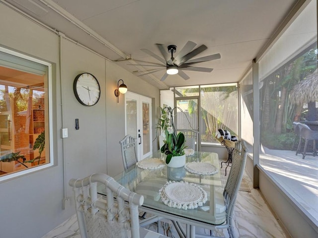 sunroom featuring ceiling fan and french doors