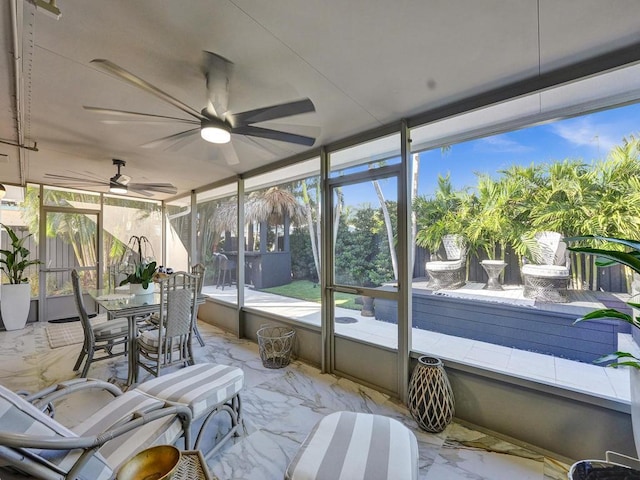 sunroom featuring ceiling fan