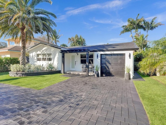 single story home with a front lawn and a garage