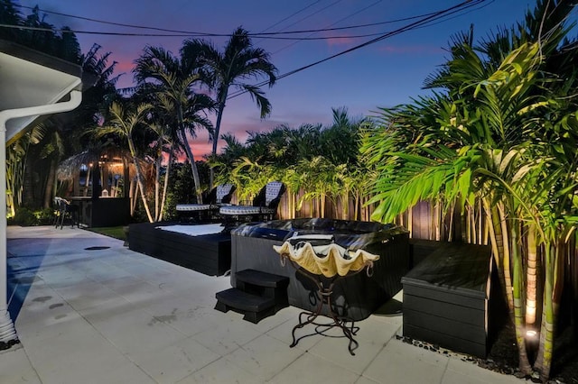 patio terrace at dusk with a hot tub