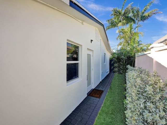 view of side of home with a lawn