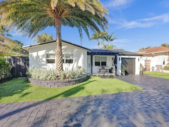 view of front of home with a front lawn and a garage