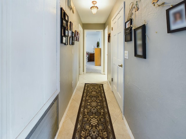 hall featuring light tile patterned flooring