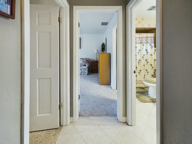 corridor with light colored carpet