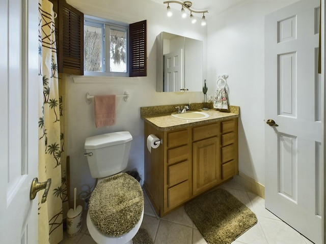 bathroom featuring toilet, vanity, and tile patterned flooring