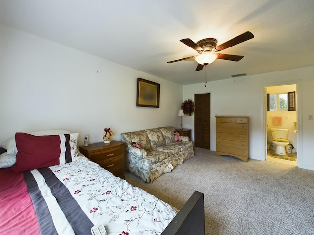 carpeted bedroom with ceiling fan and ensuite bathroom