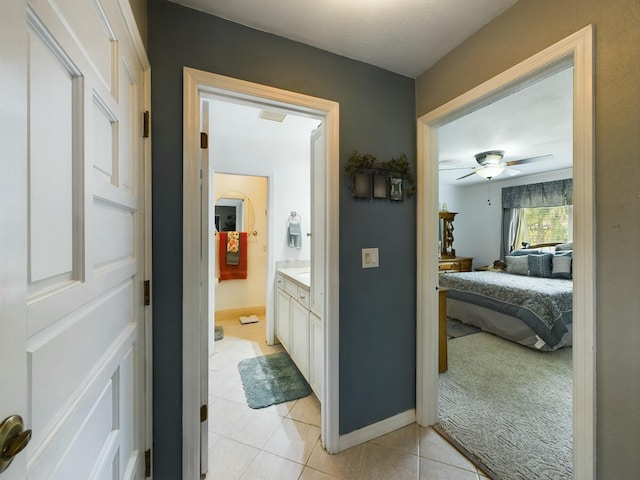 bathroom featuring tile patterned flooring, ceiling fan, and vanity