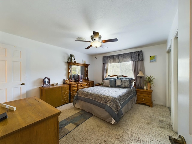 bedroom with light colored carpet and ceiling fan