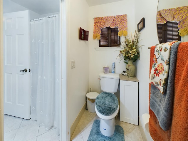 bathroom with toilet and tile patterned flooring