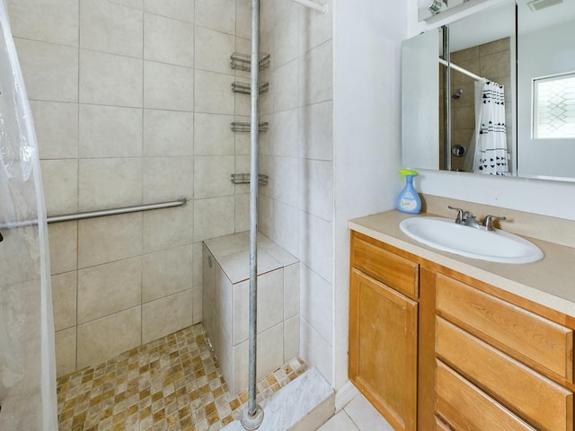 bathroom with curtained shower, tile patterned floors, and vanity