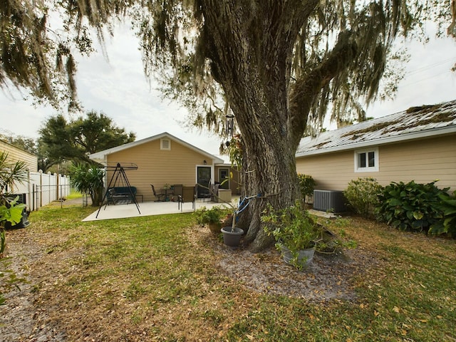 view of yard featuring central air condition unit and a patio area