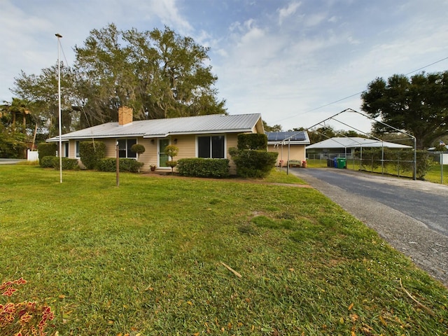 ranch-style home with a front yard and a carport