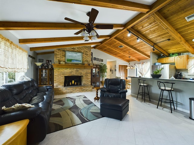 living room featuring ceiling fan, wooden ceiling, lofted ceiling with beams, and a brick fireplace