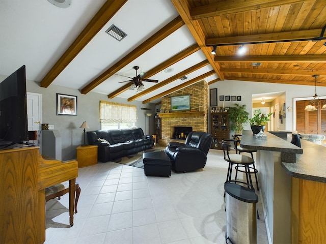 tiled living room with a fireplace, ceiling fan with notable chandelier, and lofted ceiling with beams