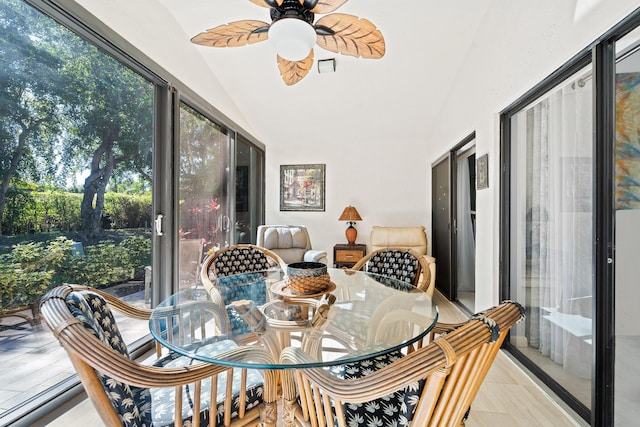 sunroom / solarium with ceiling fan and lofted ceiling