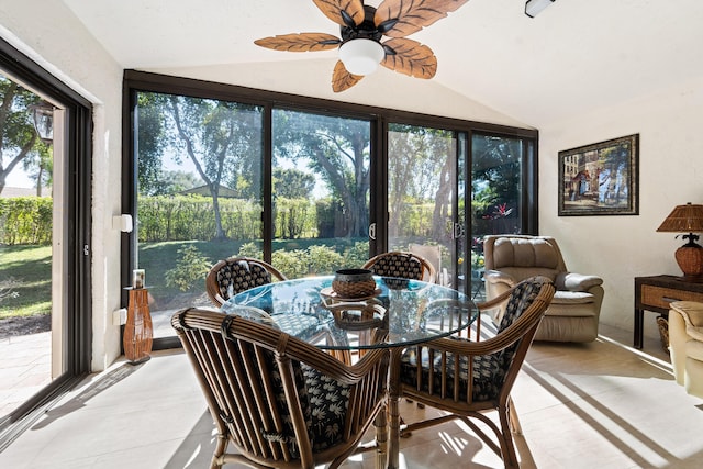 dining room with light tile patterned floors, ceiling fan, and lofted ceiling