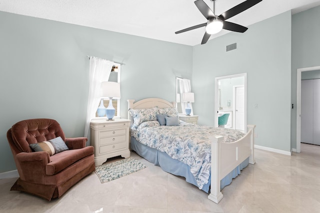 bedroom featuring ceiling fan, baseboards, visible vents, and ensuite bath