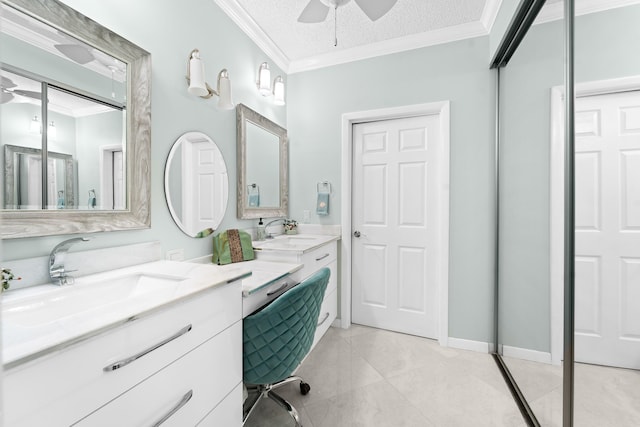 bathroom with ceiling fan, a textured ceiling, crown molding, vanity, and tile patterned floors