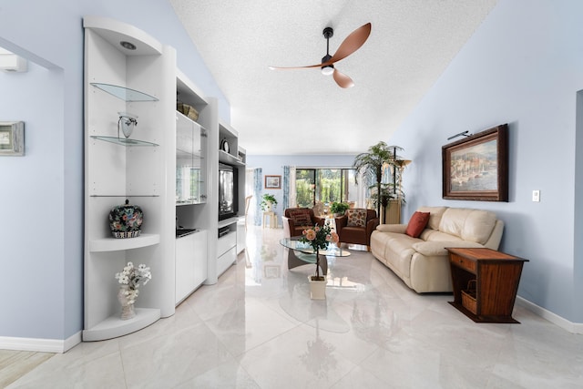 living room with baseboards, vaulted ceiling, a textured ceiling, and a ceiling fan
