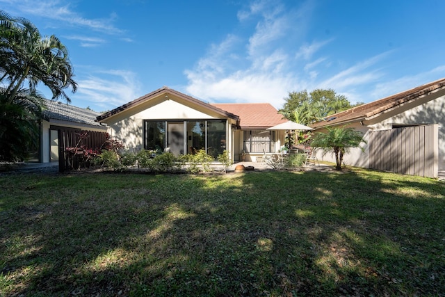 rear view of property with a lawn