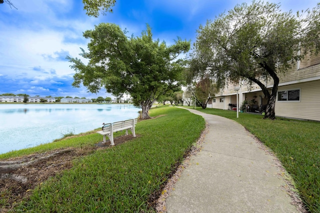 view of community featuring a water view and a yard