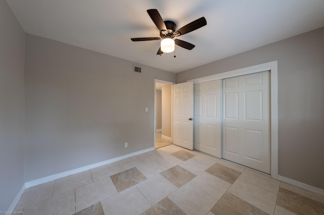 unfurnished bedroom with a closet, light tile patterned floors, and ceiling fan