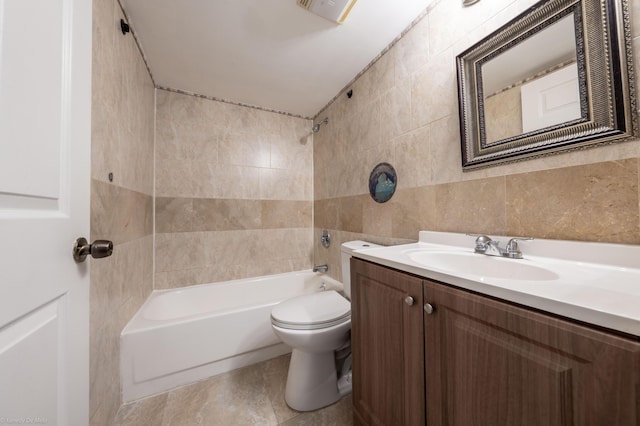 full bathroom with vanity, toilet, tub / shower combination, and tile walls