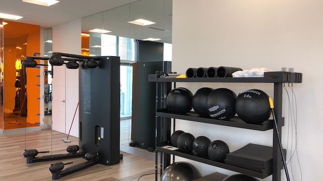 workout area with light hardwood / wood-style flooring