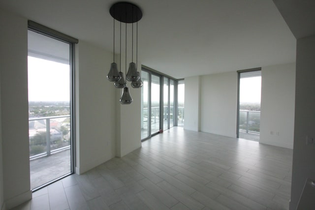 unfurnished room featuring expansive windows