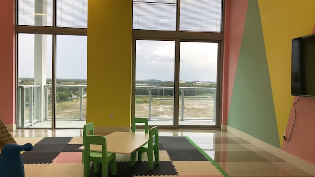 tiled dining room featuring expansive windows