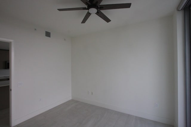 empty room featuring ceiling fan and light hardwood / wood-style flooring